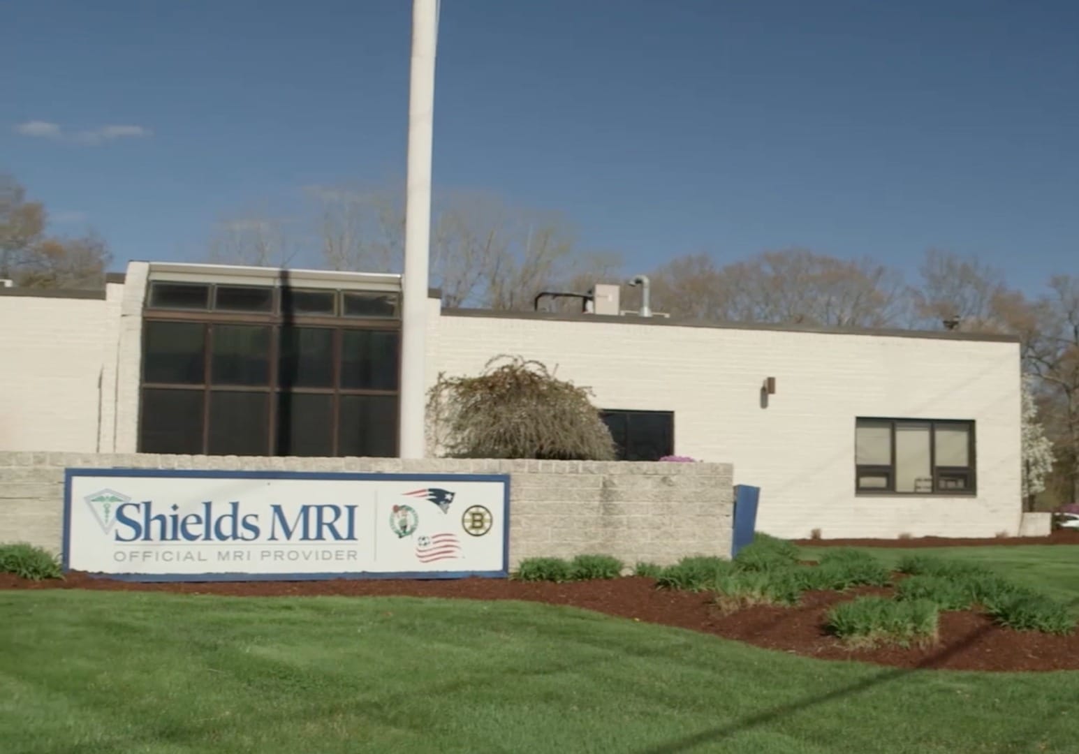 exterior view of a building with a sign reading Shields MRI official MRI provider next to Patriots and Harvard Pilgrim logos