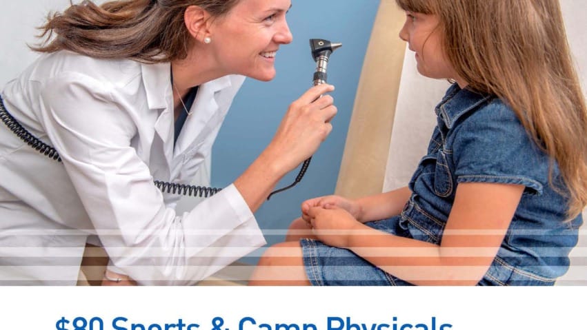 Doctor examining a young girl with an otoscope at a medical clinic, advertisement for sports and camp physicals.
