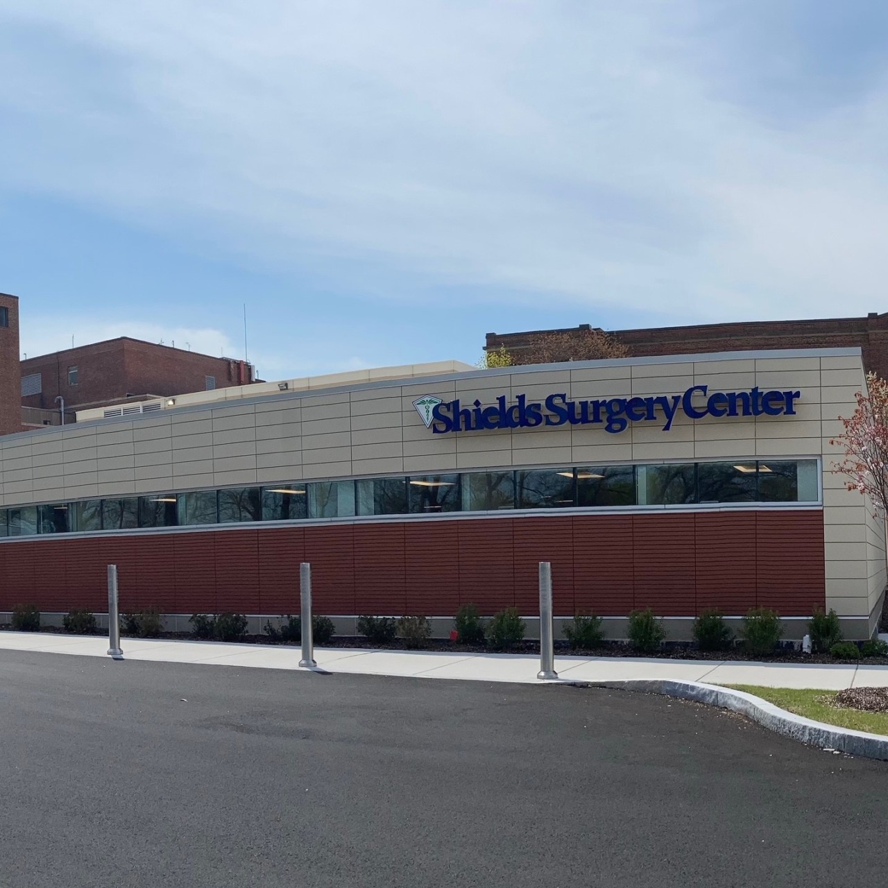 Exterior view of Shields Surgery Center building with a clear blue sky in the background.