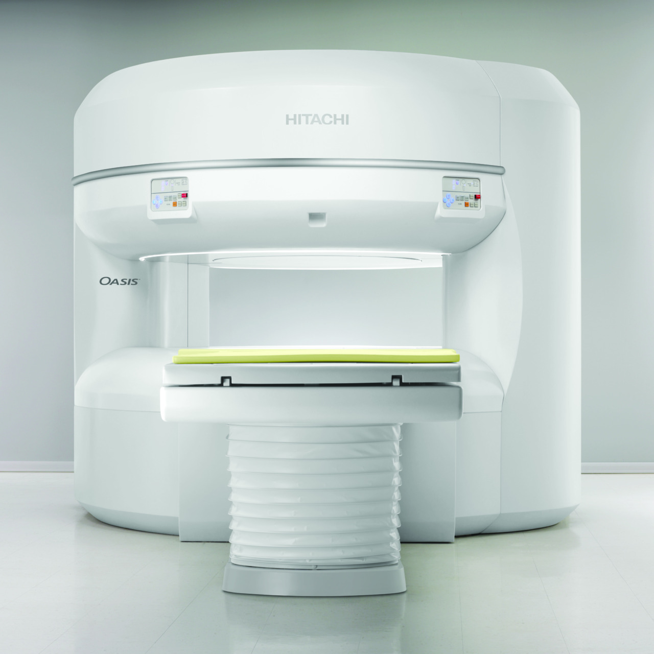 MRI machine in a clinical setting with a patient table and control panels, designed for medical imaging purposes.