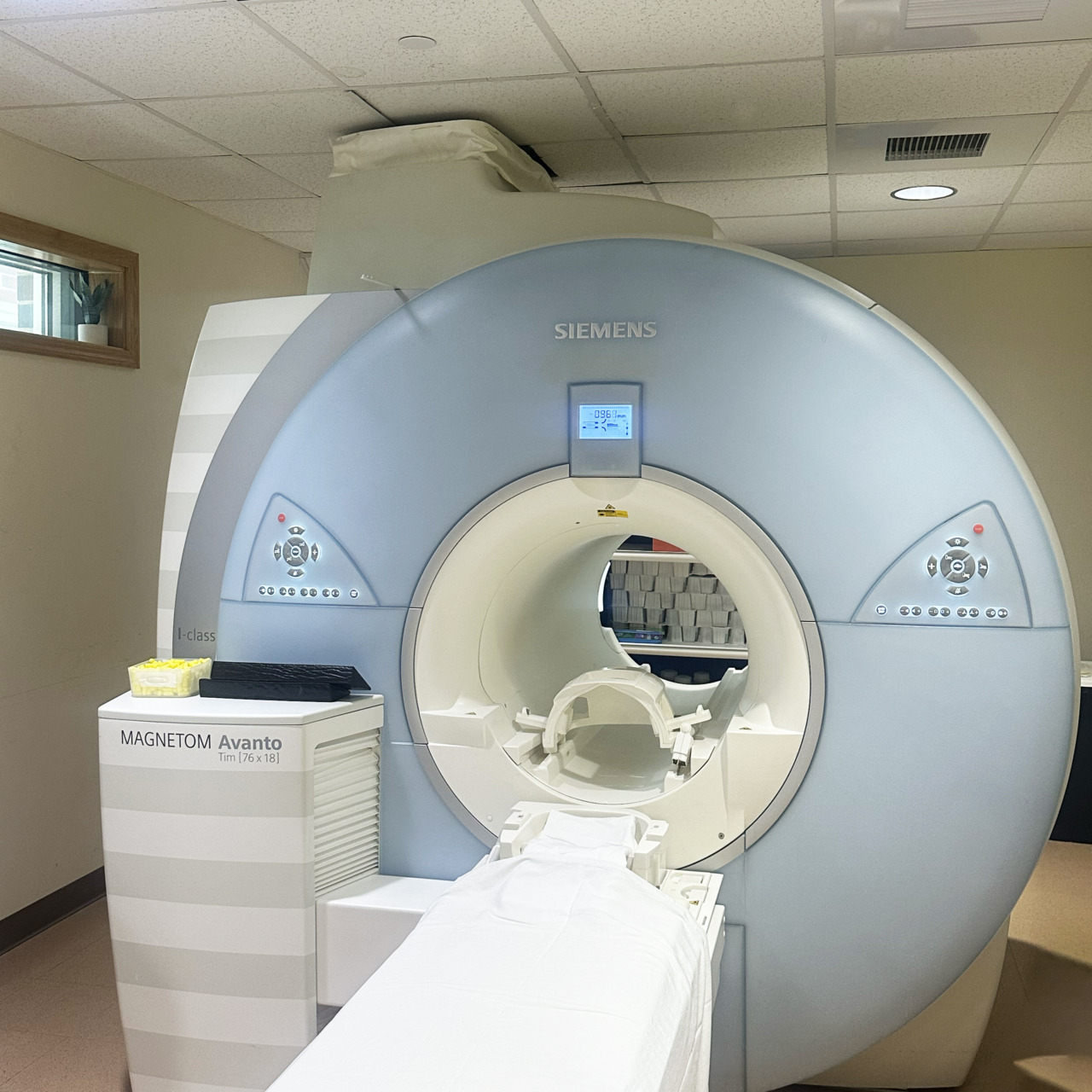 MRI machine in a hospital room, with digital display and clean surroundings, ready for medical imaging.