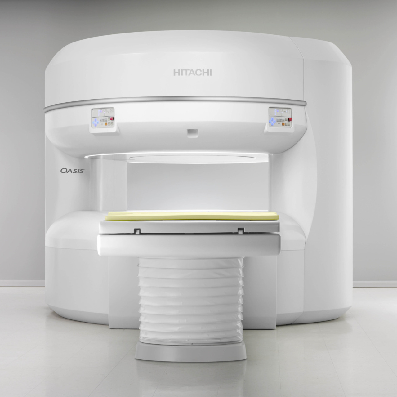 MRI machine in a medical room with a white exterior and digital screens on a smooth, modern design.
