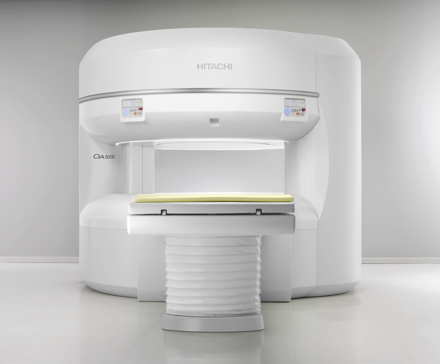 MRI machine in a medical room with a white exterior and digital screens on a smooth, modern design.