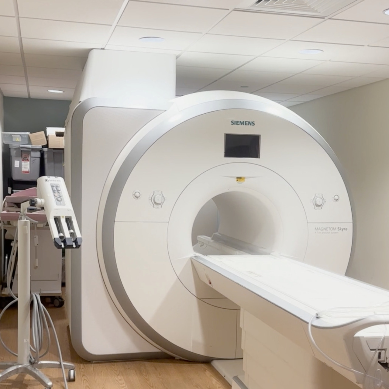 MRI machine in a medical facility with a patient bed positioned for scanning.
