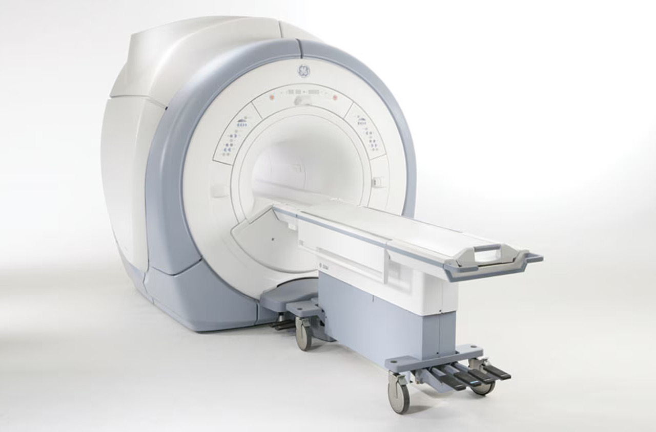 MRI machine with a sliding patient table in a hospital room.