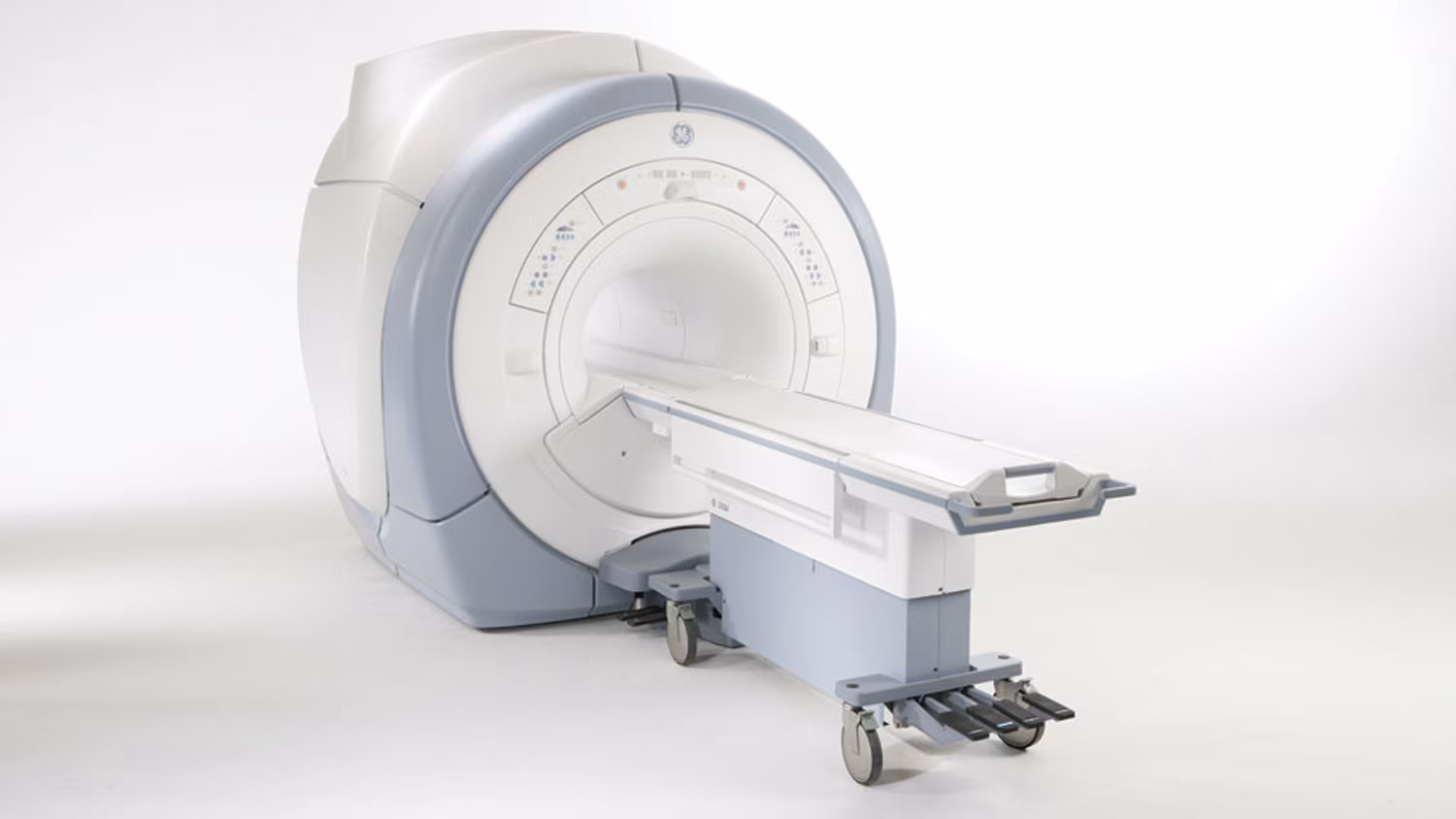 MRI machine with a sliding patient table in a hospital room.