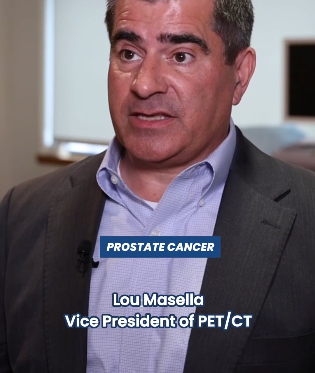 Man in a suit speaking about prostate cancer, labeled as Vice President of PET/CT in a professional setting.